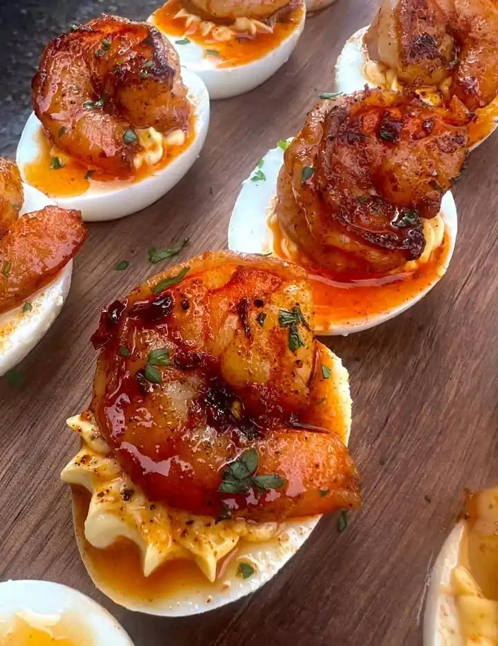 Hot Honey Shrimp Deviled Eggs garnished with herbs and spices