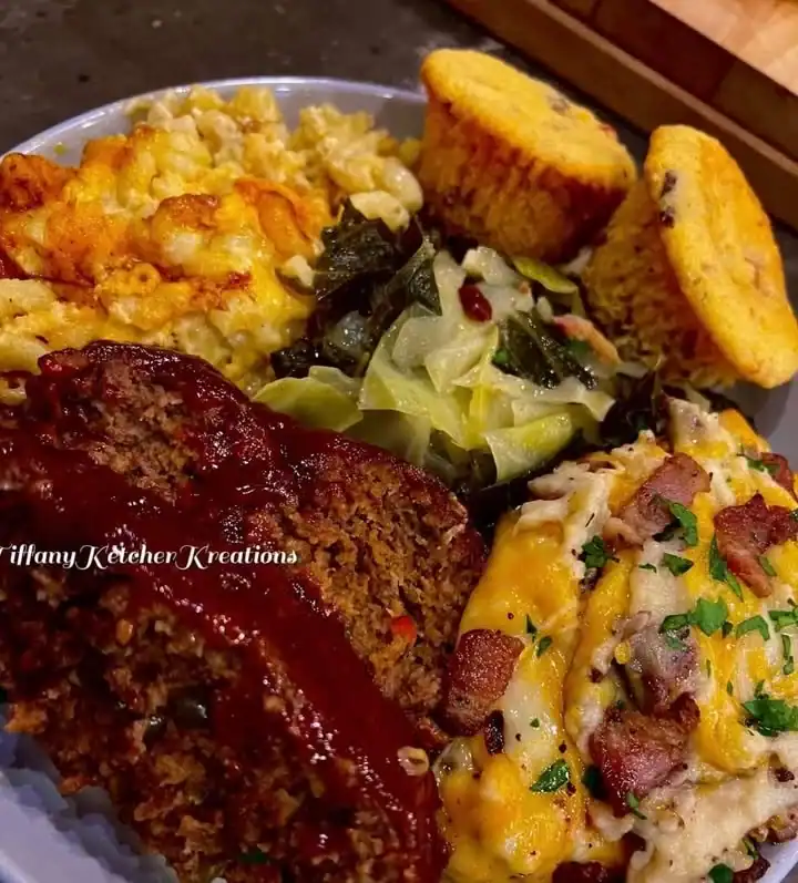 Plate of homemade meatloaf served with mashed potatoes and green beans